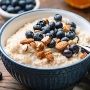 Bowl of high protein oatmeal with almonds and blueberries.